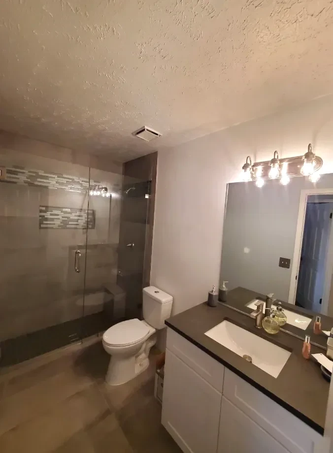 Remodeled bathroom with a new vanity, tile, and modern finishes