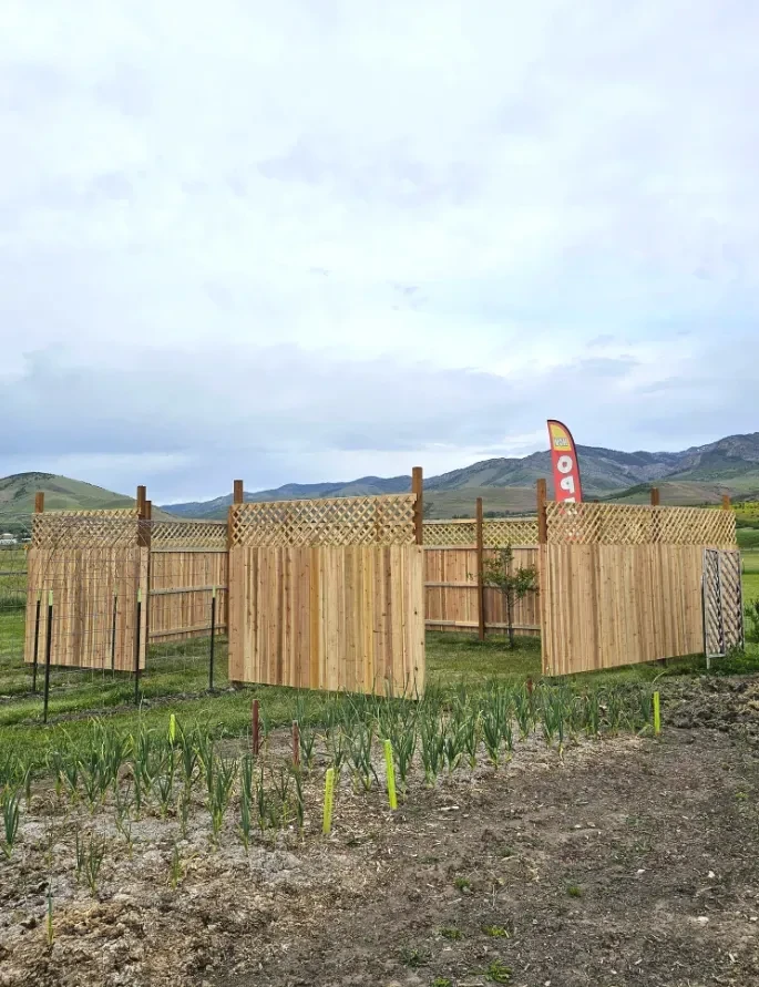 Finished cedar privacy fence enclosing a garden