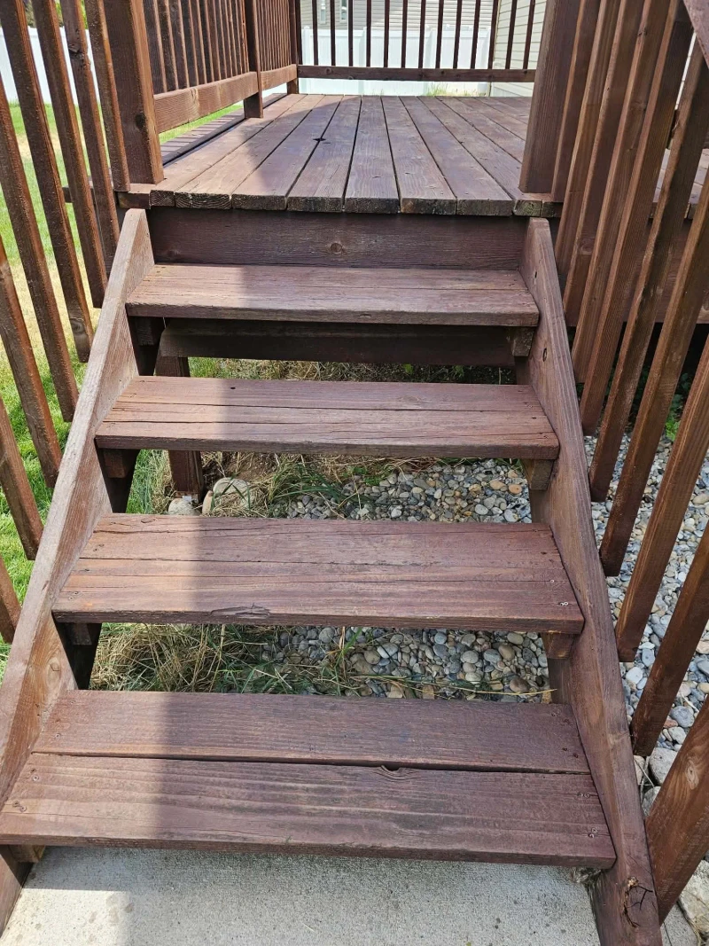 Deck stairs after refinishing with every tread stained a deep red-brown