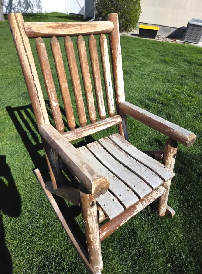 Weathered log rocking chair before refinishing