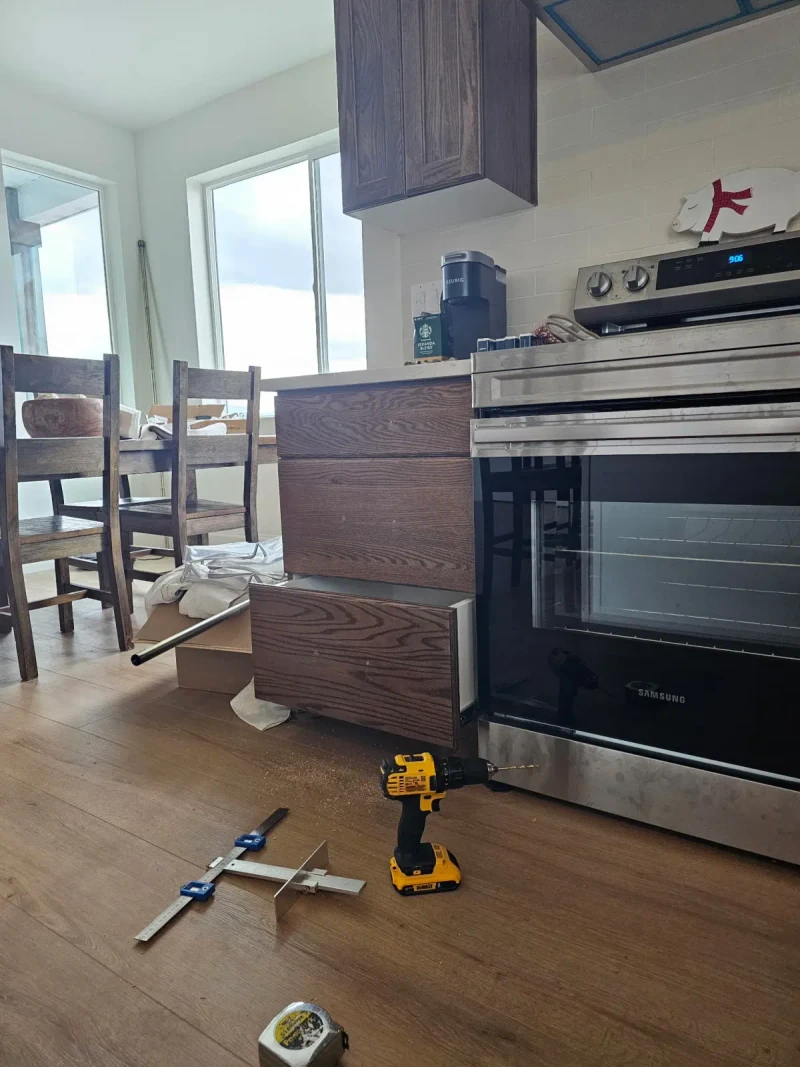 Drilling kitchen island drawer fronts for new pulls with a hardware jig