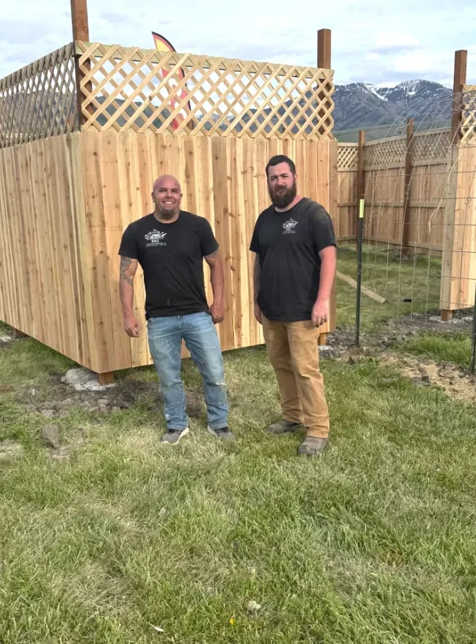 Seth and Collin, owners of S&C Handyman Services, in front of a completed cedar fence