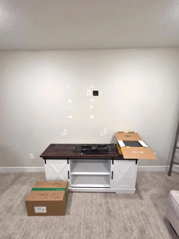Living room wall and media console prepped before TV mounting