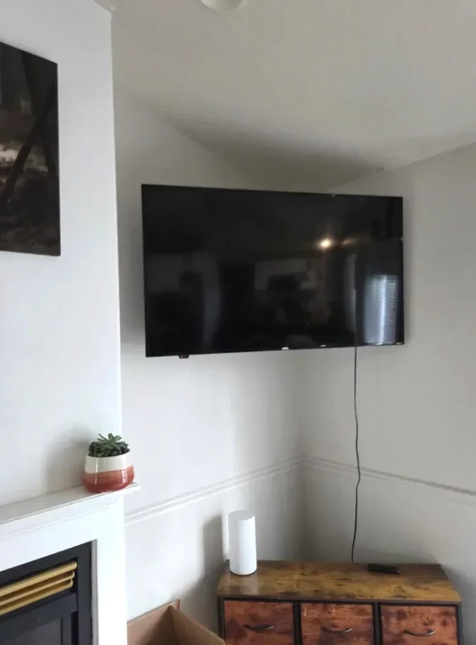 Flat-screen TV mounted on the wall above a fireplace